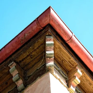 A close-up of a home's corner in Austin, TX, highlighting the soffit and fascia, showcasing the essential structural elements that support and protect the gutter system.