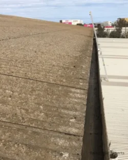 A photo of an industrial side gutter being cleaned in Austin, TX.