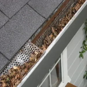 This photo shows a blocked gutter with leaves in Austin, TX, in need of professional Gutter Cleaning Austin to restore proper drainage and prevent water damage.